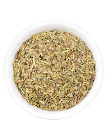 Eine weiße Schale gefüllt mit einer fein geschnittenen, hellgrünen bis beigen Kräutermischung mit roten Sprenkeln.