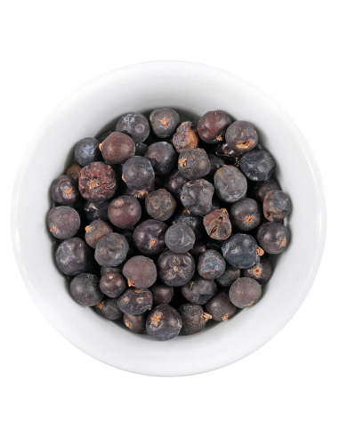 Weiße Schale mit runden, dunkellilafarbenen Wacholderbeeren.