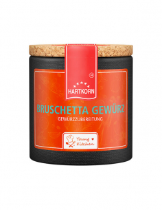 Pappdose mit Korkdeckel und orangefarbenem Etikett, beschriftet mit „Bruschetta Gewürz“.