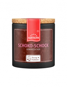 Pappdose mit Korkdeckel und dunkelbraunem Etikett, beschriftet mit „Schoko-Schock – Gewürzzucker“.