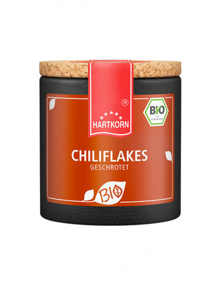 Dunkle Pappdose mit orangefarbenem Etikett und Bio Siegel, Aufschrift ‚chiliflakes geschrotet Dunkle Pappdose mit orangefarbenem Etikett und Bio Siegel, Aufschrift ‚chiliflakes geschrotet