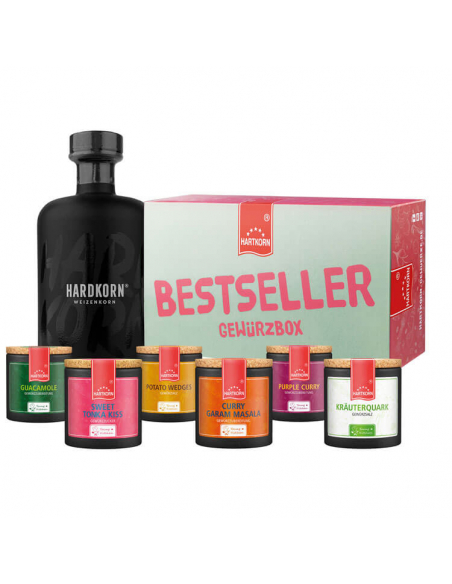 Schwarze Flasche neben sieben Pappdosen und Box mit der Aufschrift ‚Bestseller Gewürzbox‘.“