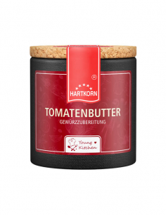 Pappdose mit Korkdeckel und rotem Etikett, beschriftet mit „Tomatenbutter“.