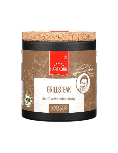 Schwarze Pappdose mit Korkdeckel, Etikett in Braun mit rotem Band: 'Hartkorn Grillsteak Gewürzmischung', BIO-Siegel sichtbar. Schwarze Pappdose mit Korkdeckel, Etikett in Braun mit rotem Band: 'Hartkorn Grillsteak Gewürzmischung', BIO-Siegel sichtbar.
