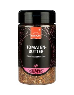 Schwarze Gewürzdose mit pinkfarbenem Etikett und der Aufschrift „Tomatenbutter“.