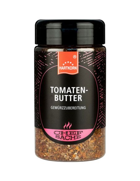 Schwarze Gewürzdose mit pinkfarbenem Etikett und der Aufschrift „Tomatenbutter“.