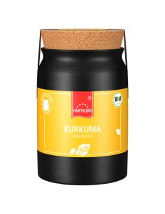 Schwarzes Keramiktöpfchen mit gelbem Etikett und der Aufschrift „Kurkuma gemahlen“.