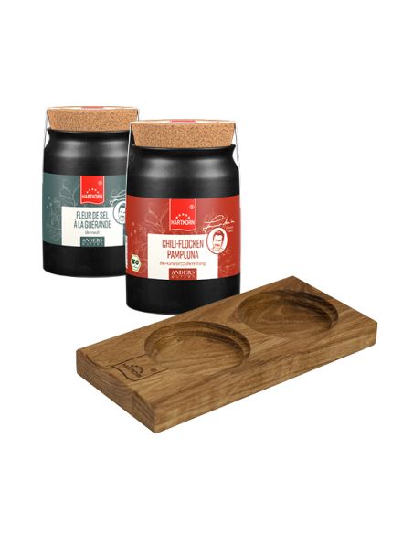 Zwei schwarze Keramiktöpfchen mit Holzdeckel und Holzhalterung für zwei Töpfchen.