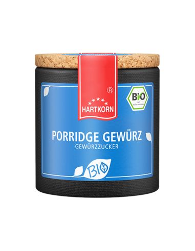 Dunkelblaue Keramikdose mit rotem Etikett und Korkdeckel, beschriftet mit „Porridge Gewürz – Bio“.