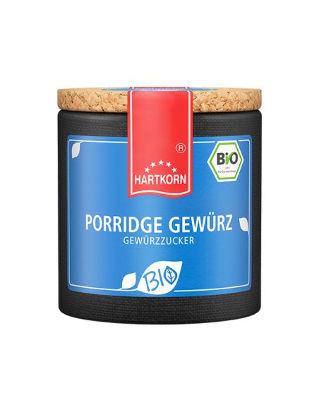 Dunkelblaue Keramikdose mit rotem Etikett und Korkdeckel, beschriftet mit „Porridge Gewürz – Bio“.