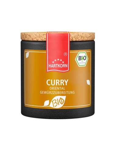 Pappdose mit Korkdeckel und gelb-orangefarbenem Etikett mit der Aufschrift „Curry“.