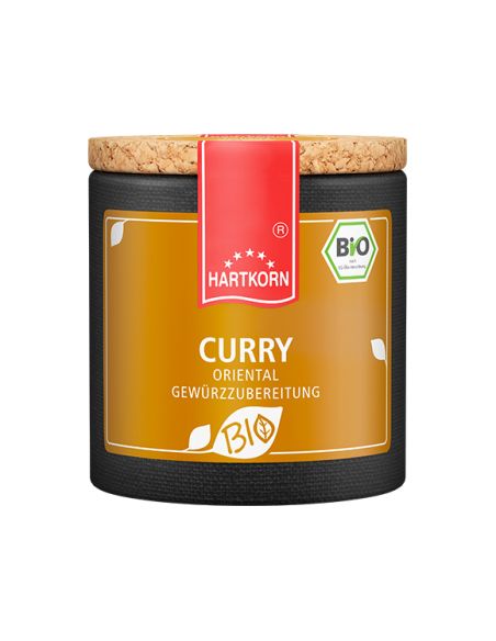 Pappdose mit Korkdeckel und gelb-orangefarbenem Etikett mit der Aufschrift „Curry“. Pappdose mit Korkdeckel und gelb-orangefarbenem Etikett mit der Aufschrift „Curry“.
