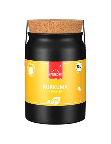 Schwarzer Keramiktopf mit gelbem Etikett und Korkverschluss, beschriftet mit „Kurkuma“.