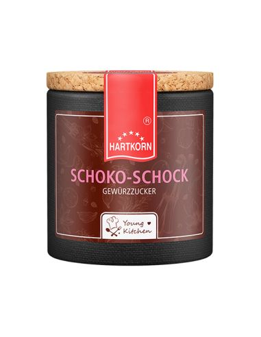 Dunkelbraune Pappdose mit Korkdeckel und rotem Etikett, Aufschrift „Schoko-Schock“.