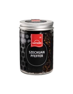 Glas mit dunklem Szechuan Pfeffer und silbernem Schraubdeckel