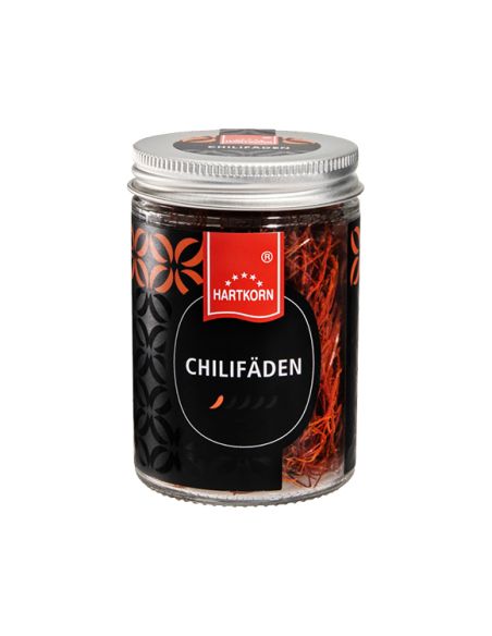 Hartkorn Glas mit roten Chilifäden, silbernem Schraubdeckel und Etikett mit einer stilisierten Chilischote als Schärfegrad