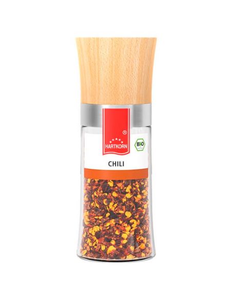 Durchsichtige Gewürzmühle mit Holzdeckel. Etikett mit rotem Hartkorn-Logo und der Aufschrift „Chili-Flocken“. Durchsichtige Gewürzmühle mit Holzdeckel. Etikett mit rotem Hartkorn-Logo und der Aufschrift „Chili-Flocken“.