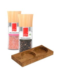 Zwei Gewürzmühlen mit Holzdeckel und Holzhalterung, gefüllt mit rosa Salz und schwarzen Pfefferkörnern.