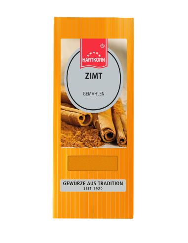 Orangefarbene Verpackung mit ovalem Ettiket und der Aufschrift "Zimt" mit einem Bild von Zimtstangen.
