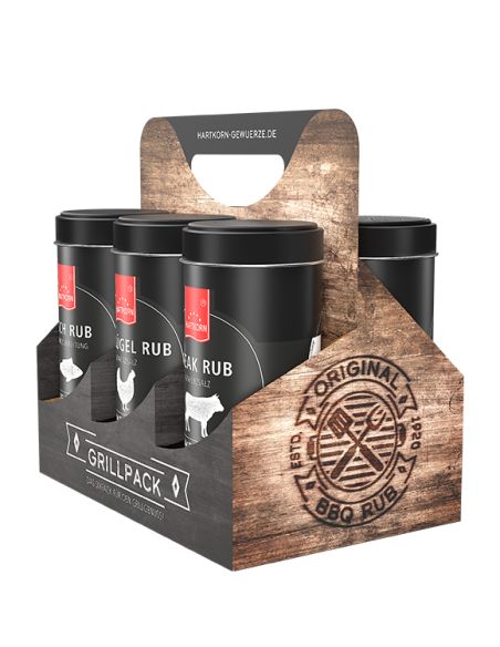 Sechsteiliges Gewürz-Set in schwarzen Dosen mit rotem Etikett, verpackt in einem rustikalen Tragekarton mit Griff.