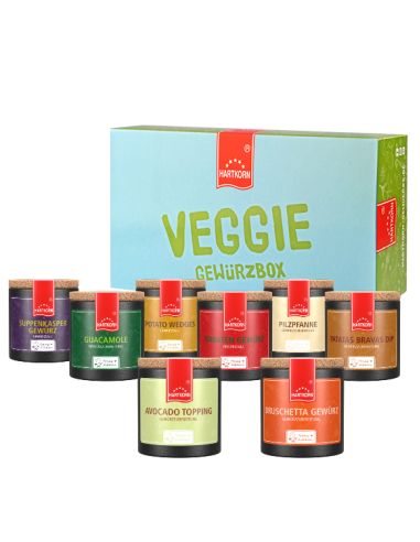 Hellgrüne Box mit der Aufschrift „Veggie Gewürzbox“, davor neun farbige Pappdosen mit Gewürzen.