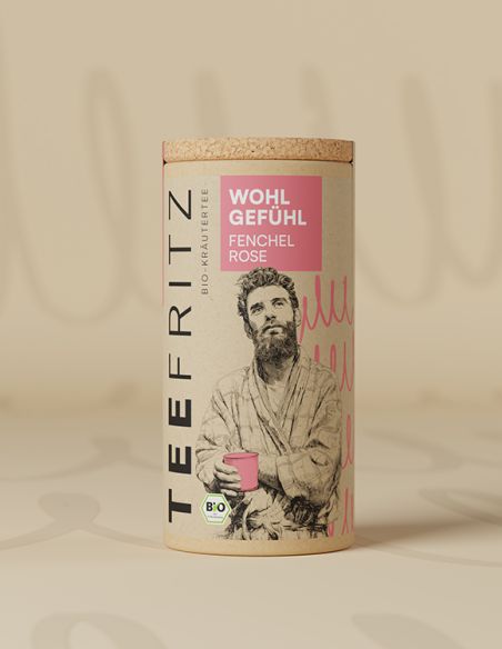 Teefritz Dose „Wohl Gefühl“ Fenchel Rose, mit Illustration eines Mannes im Bademantel und rosa Etikett.