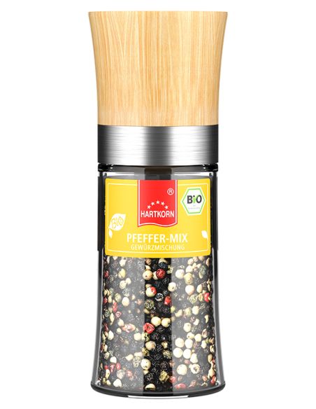 Eine Holz-Gewürzmühle mit durchsichtigem Behälter, gefüllt mit Pfefferkörnern. Auf dem Etikett steht „Pfeffer bunt“.