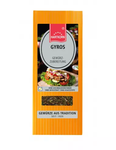 Flachbeutel mit der Aufschrift „GYROS“, im Hintergrund Gyrosgericht mit Zwiebeln und frischen Kräutern.